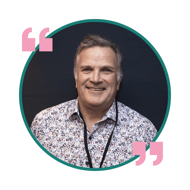 Photo of Paul Green in a circle with a green border. A pink quote symbol is displayed at the top left and bottom right.